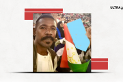 مشجع سوداني يحمل علم طاجيكستان