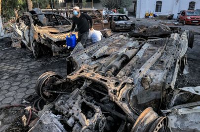 سيارات محترقة ورجل يحمل بقايا في المستشفى المعمداني بغزة