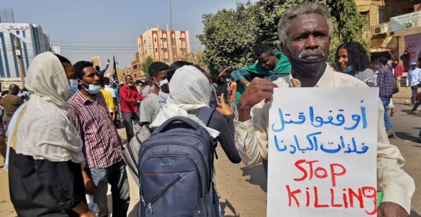 رجل يحمل لافتة تطالب بوقف القتل في احتجاجات مناهضة للحكم العسكري في السودان